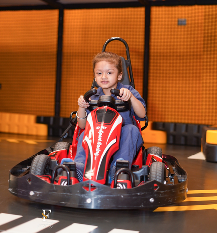 Child enjoying indoor go-karting at Wooray Elite Ludhiana