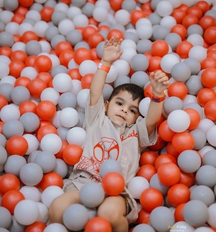 Child enjoying the colourful soft play ball pit at Wooray Elite Ludhiana