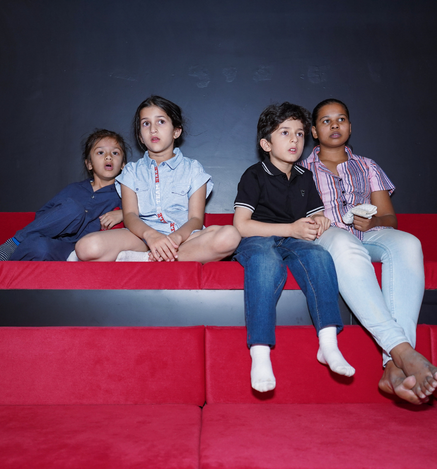 Children enjoying a movie in the Mini Movie Theatre at Wooray Elite Ludhiana